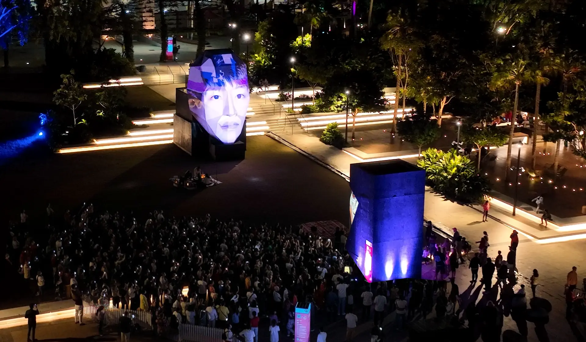 ECHO’s illuminated face sculpture and gathered audience, viewed from above.