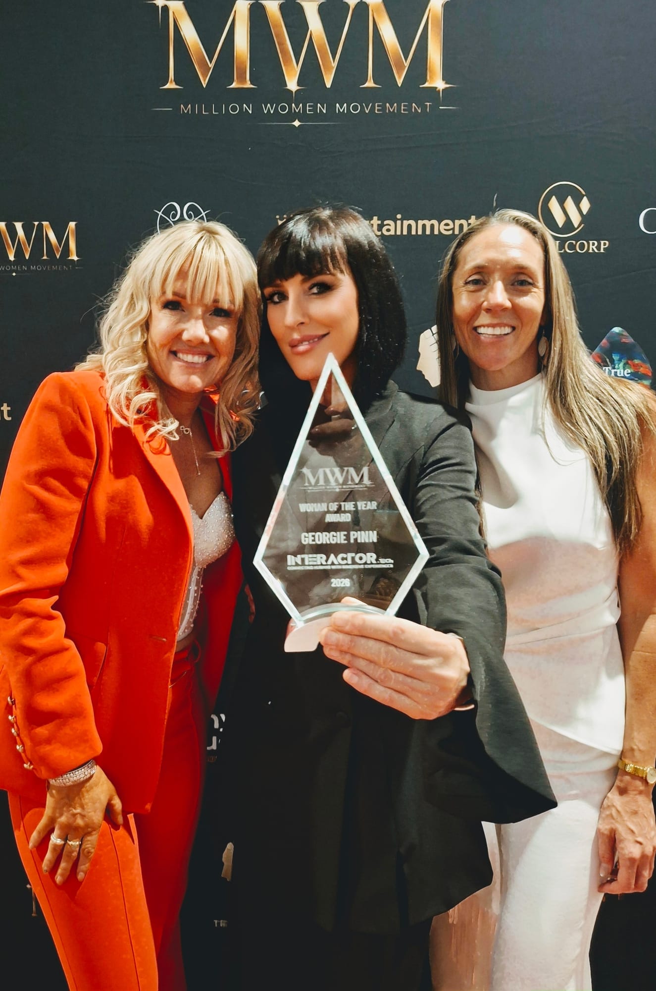 Georgie Pinn holding her 2026 Woman of the Year trophy at the Million Women Movement event.